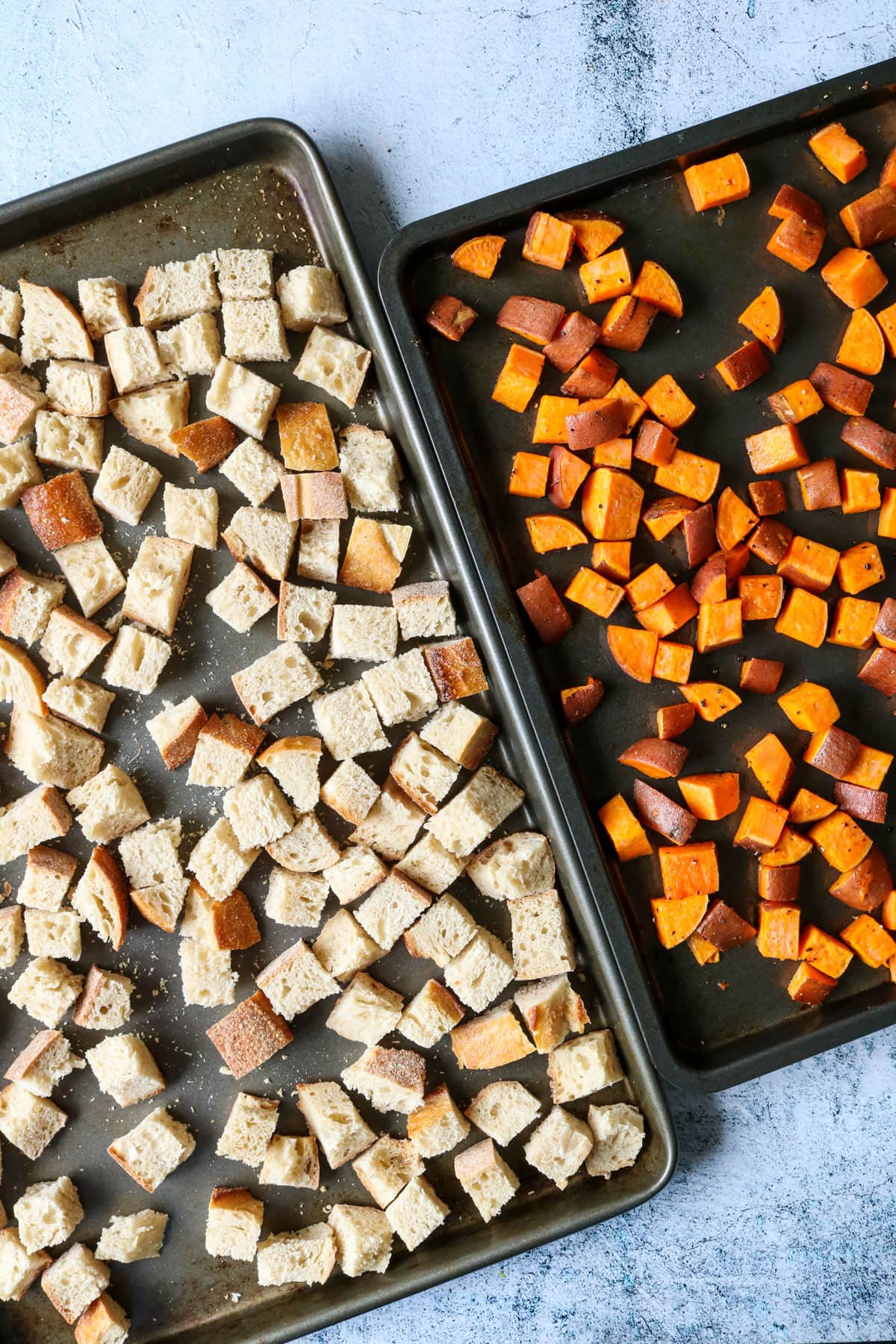 Toasted bread and sweet potatoes on a baking sheet. 