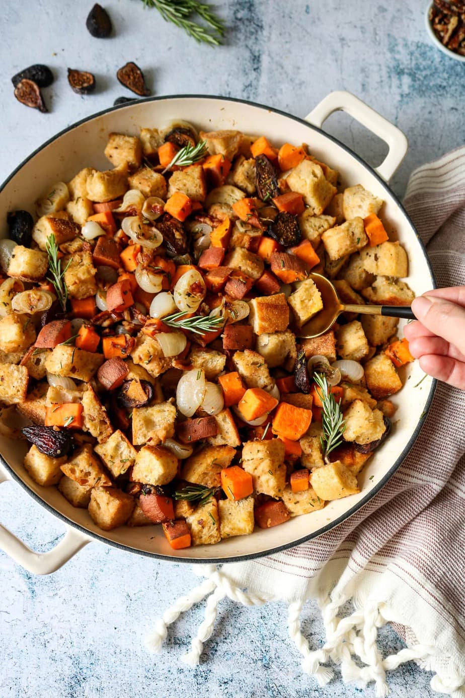 Sweet Potato, Fig, and Rosemary Stuffing in a dutch over with a golden spoon.