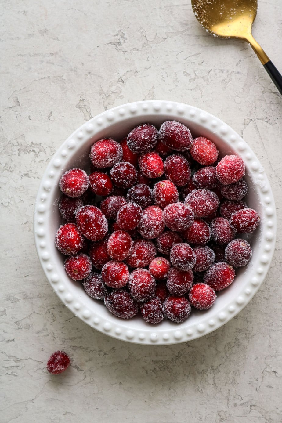 frosted cranberries in a bowl.