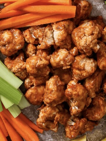 adobe cauliflower wings on a try with carrots and celery.