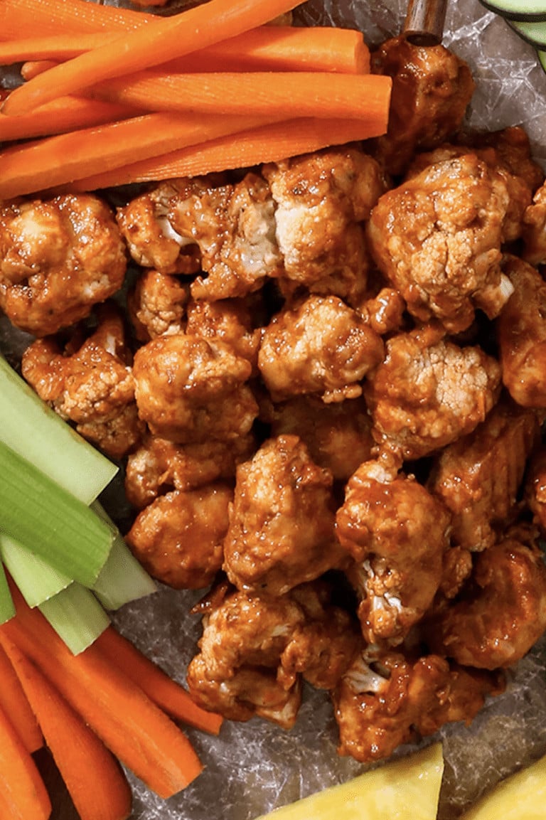 adobe cauliflower wings on a try with carrots and celery.