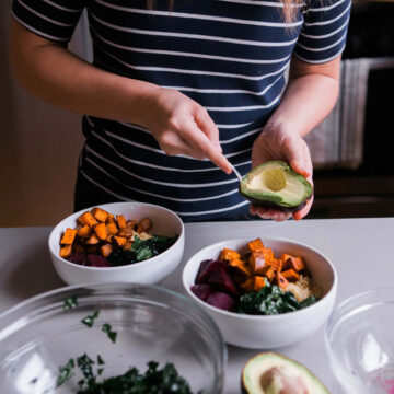 cutting up an avocado in the kitchen.