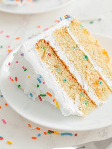 vegan funfetti birthday cake slice on a plate.