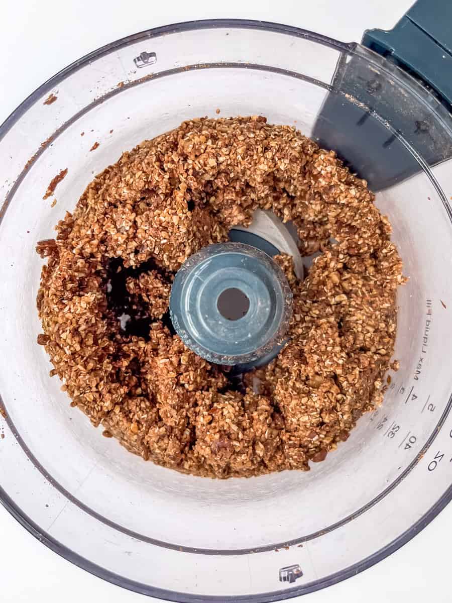 Pulsed wet and dry ingredients in the bowl of a food processor. 